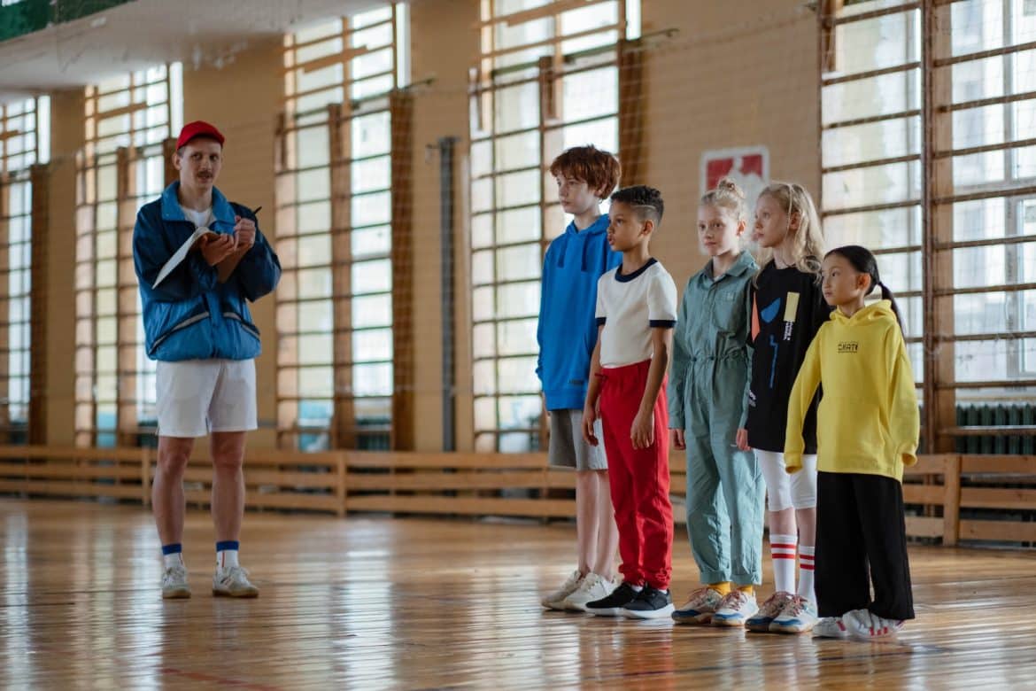 Coach and Children Standing at the Gym